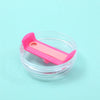 A pink replacement tumbler lid with a rectangular shape is shown inside a clear plastic container.