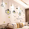 A modern living room wall decorated with various geometric and pendant light fixtures