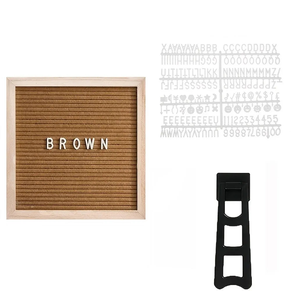A wooden letter board with the word BROWN displayed on a slat background next to a black stand.