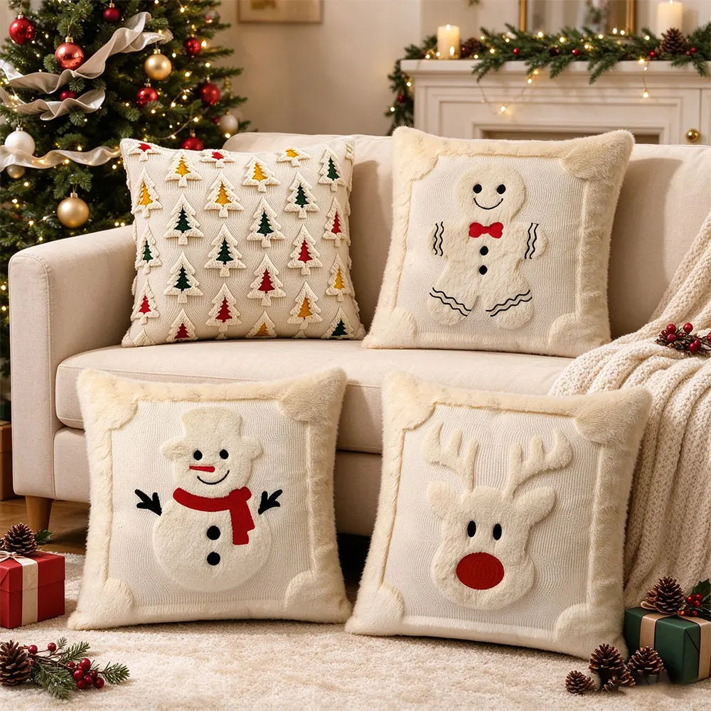 A collection of cream-colored Christmas pillows featuring white snowman and reindeer designs with red accents.