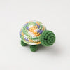 Handmade crocheted turtle plush with a mottled green and yellow shell.