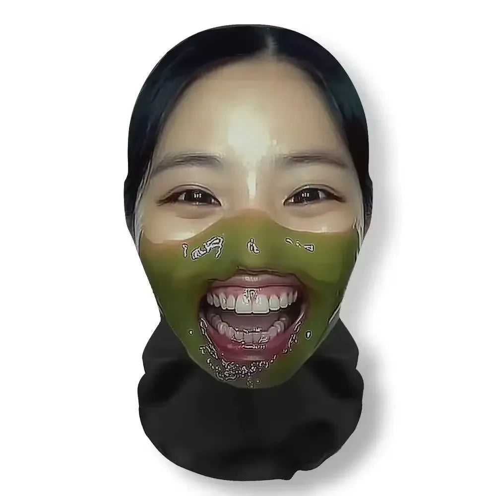 A close-up of a woman wearing a green carnival mask with visible teeth and dark hair.