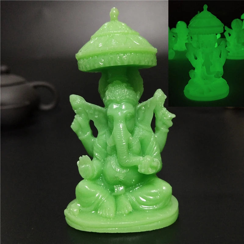A bright green statue of Ganesha Buddha seated in a meditative pose on a round base.