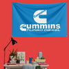 A blue banner featuring the Cummins Turbo Diesel logo on a red wall.