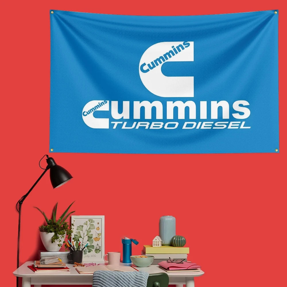 A blue banner featuring the Cummins Turbo Diesel logo on a red wall.