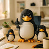 A black and white penguin desk statue with a raised flipper sitting on a wooden table.