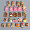 A collection of small, cute animal figures resembling capybaras and bears in various colors and textures.