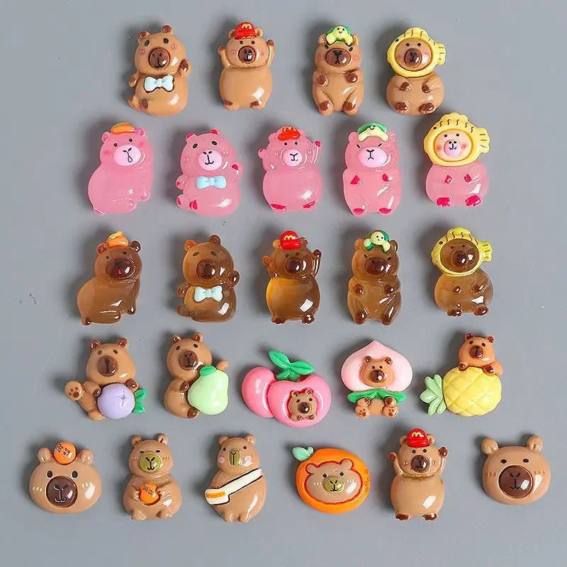 A collection of small, cute animal figures resembling capybaras and bears in various colors and textures.