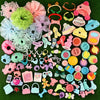 A variety pack of mini pet shop accessories including pink, green, and blue items like toys, jewelry, and fabric pieces.