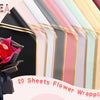 A stack of 20 sheets of flower wrapping paper with gold edges in various pastel and dark colors.