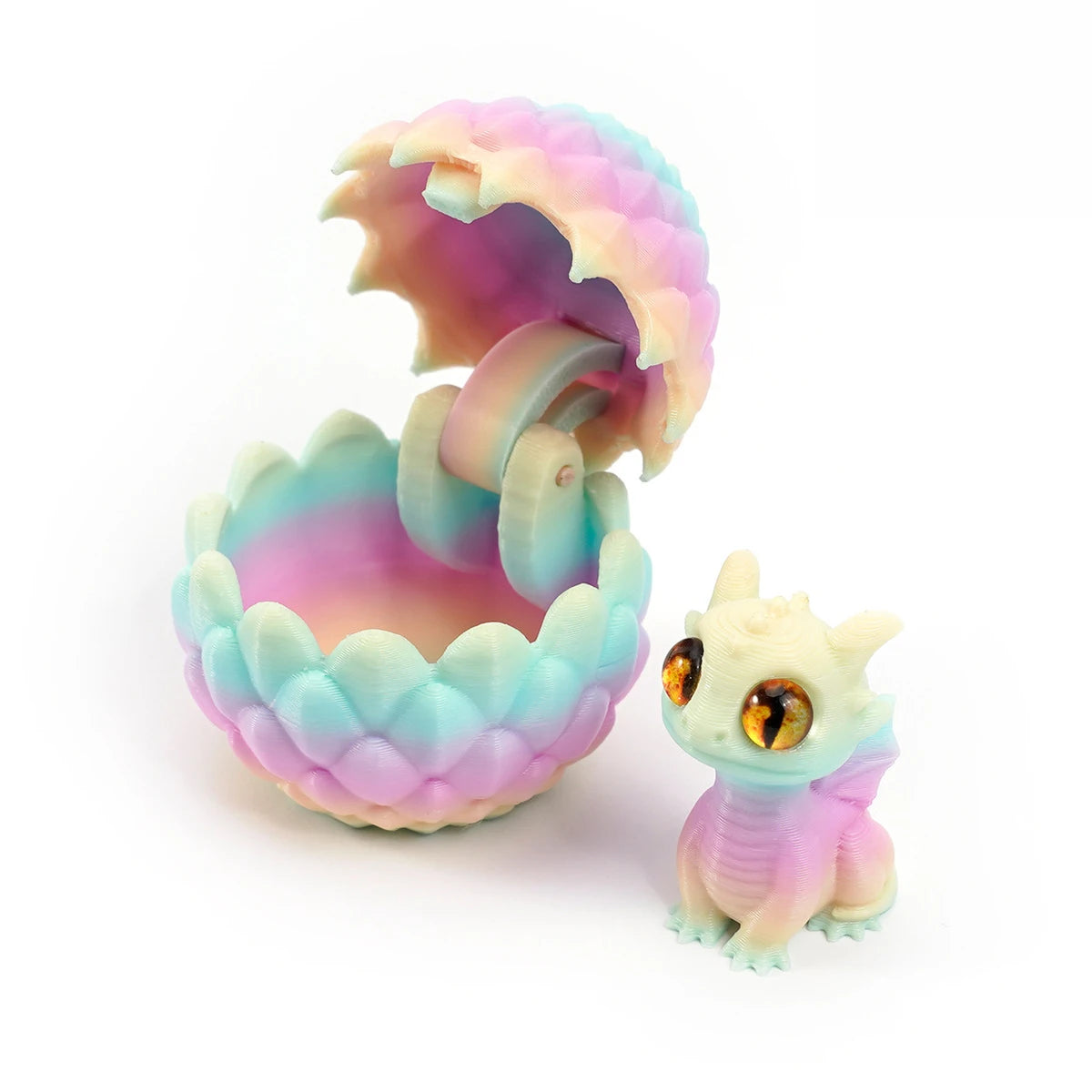 A 3D printed dragon egg is cracked open, revealing a small, light purple and blue dragon toy inside.