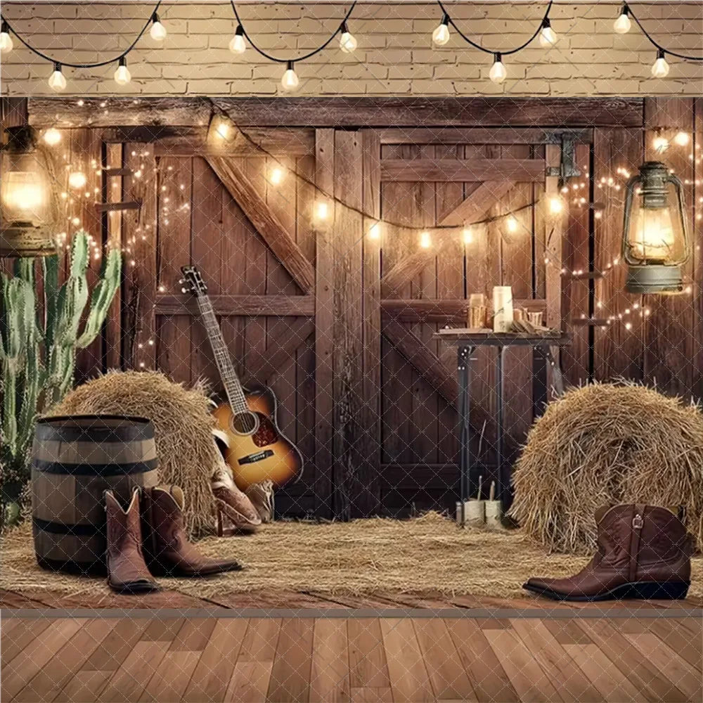 A rustic farm barn scene backdrop featuring wooden doors, hay bales, a guitar, and string lights for a wild west birthday par