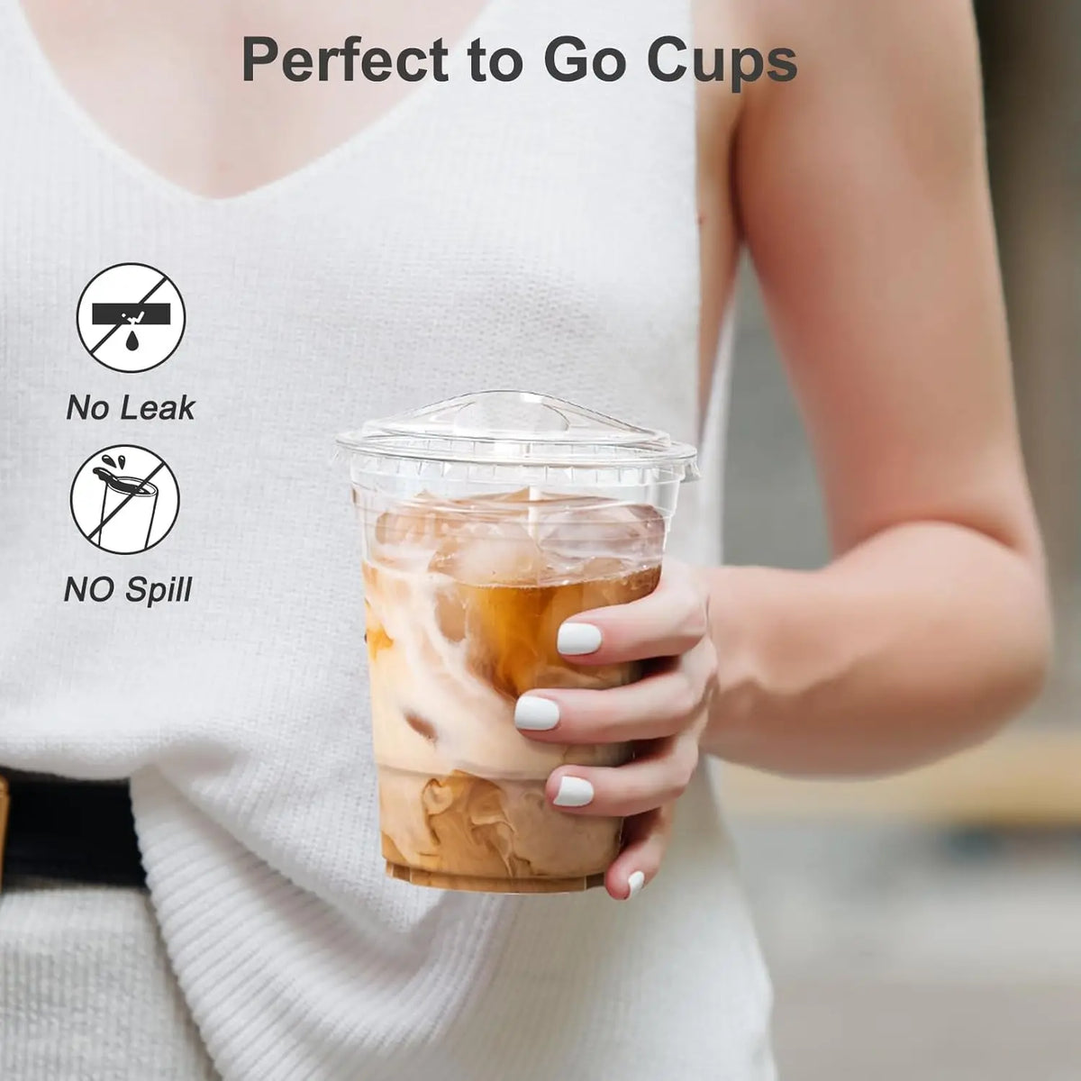 A person holds a clear plastic cup filled with iced coffee, demonstrating no leak or spill.