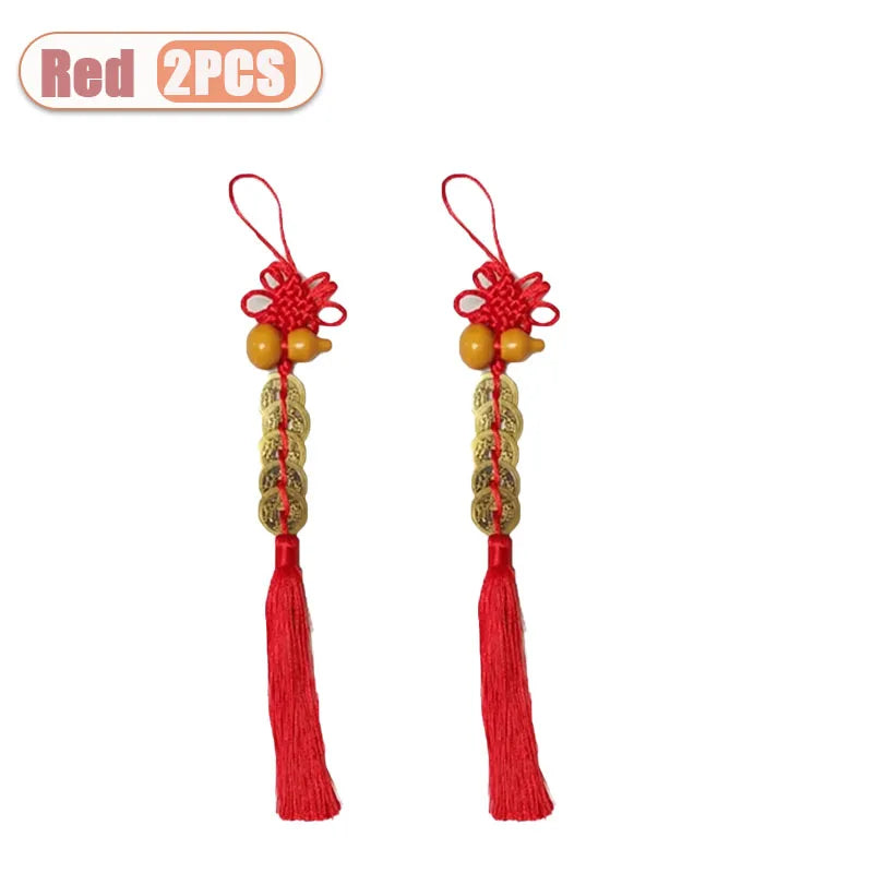 Two red traditional Chinese knot pendants featuring a wooden gourd and copper coins.