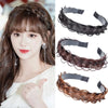 A close-up of a woman modeling dark brown braided hair bands for fashion and party