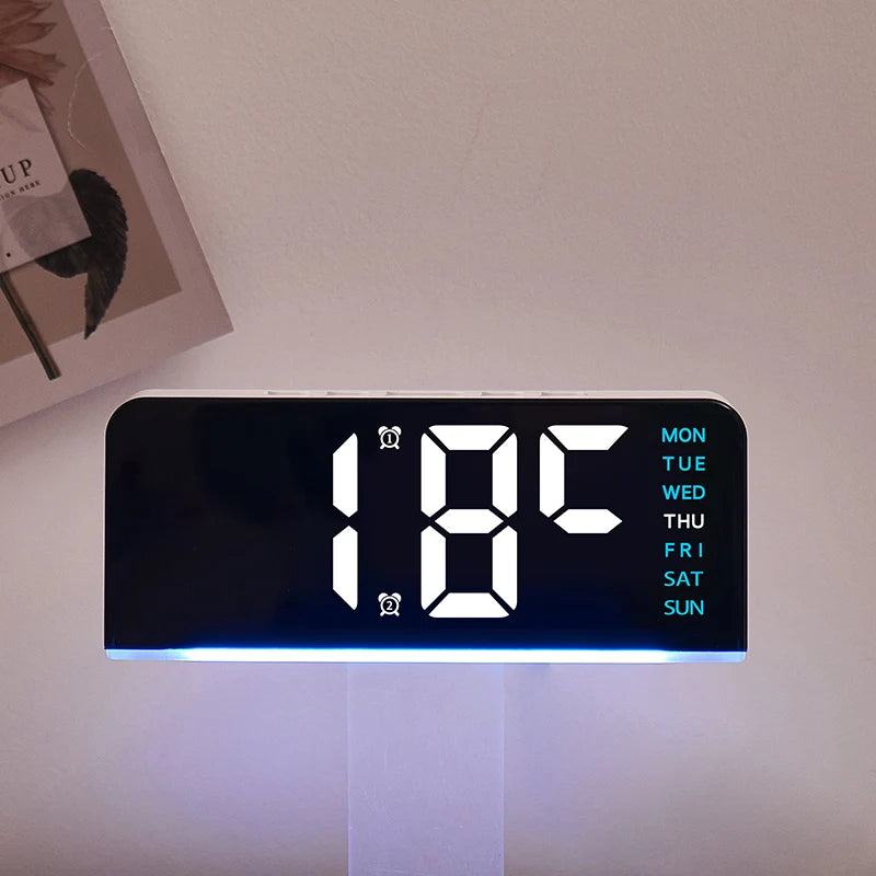 A black digital alarm clock displaying 1:08 with a blue light and a week day schedule.