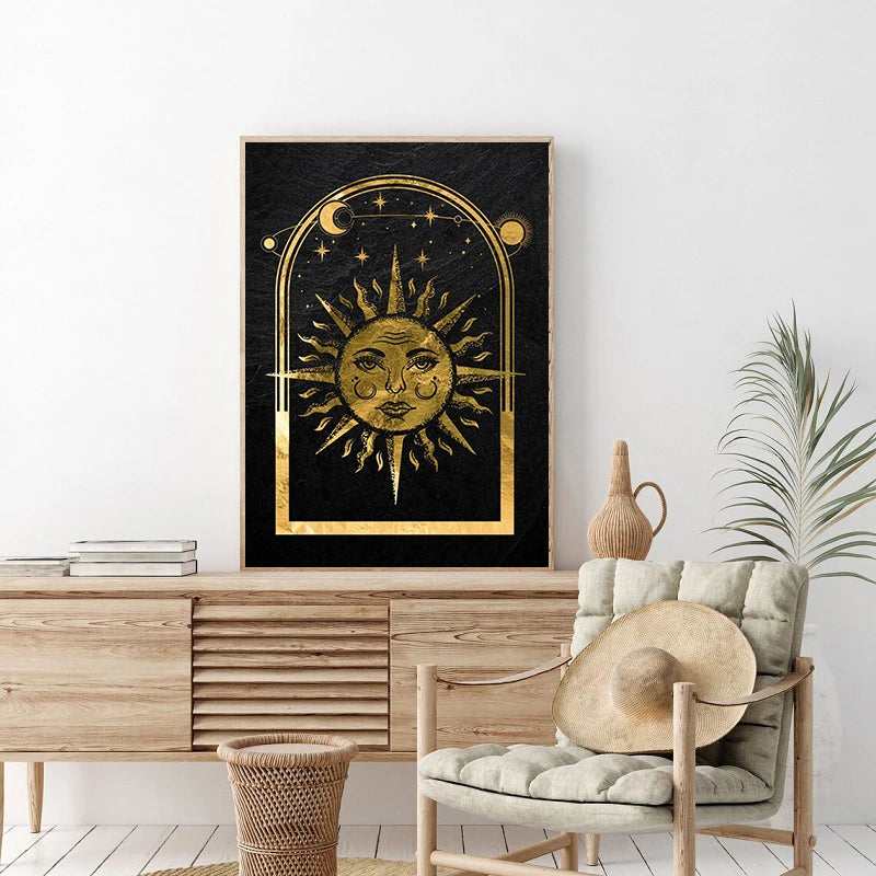 A framed canvas print featuring a golden sun and moon design on a black background.