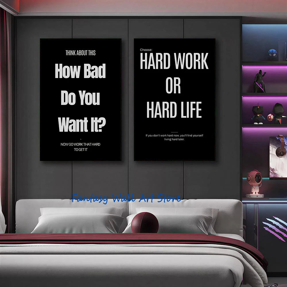 A set of two black motivational canvas wall art prints featuring quotes about hard work and life on a dark gray wall.