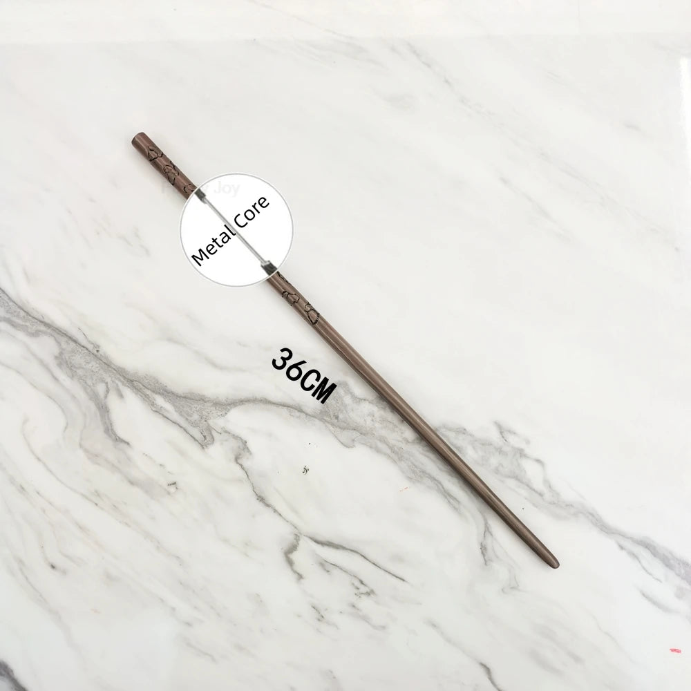 A long, thin metal wand replica with a handle and a decorative tip is displayed on a white marble surface.