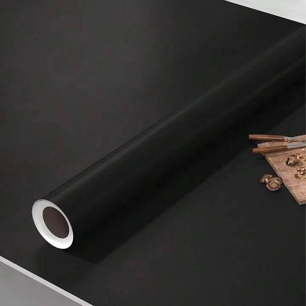 A roll of matte peel and stick decor stickers shown against a dark surface.