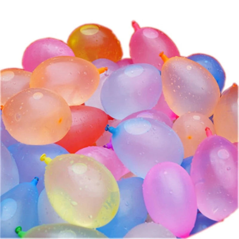 A close-up of colorful self-tying water balloons filled with water, showing various shades of pink, yellow, orange, and blue.