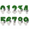 A set of green and white soccer-themed birthday candles shaped like the numbers one through seven.