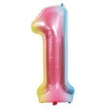 A large, shiny pink foil balloon shaped like the number one.