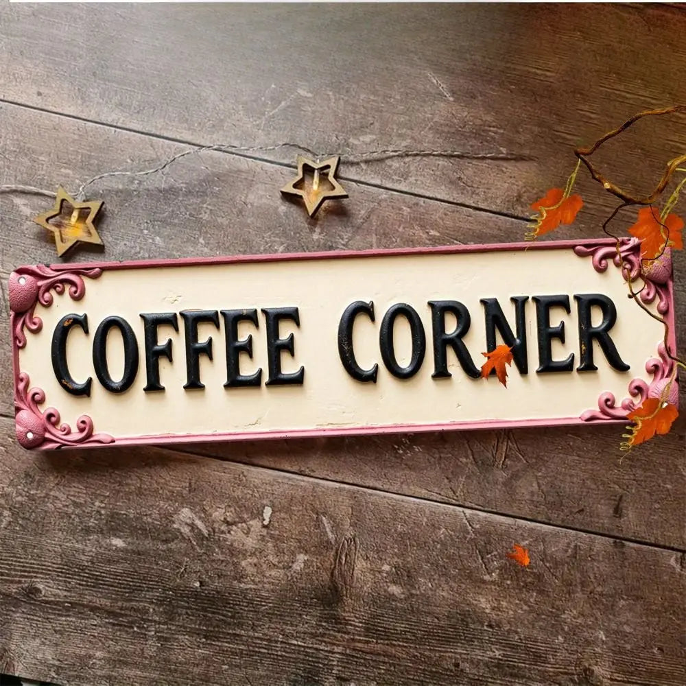 A vintage metal sign with the words COFFEE CORNER and decorative stars on a rustic wooden surface.