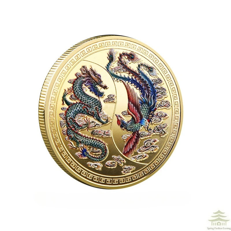 A round gold commemorative coin featuring a Chinese dragon and phoenix design.