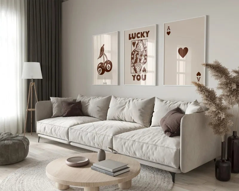 A modern living room features a light sofa and wooden coffee table with framed retro letter art canvases on the wall.