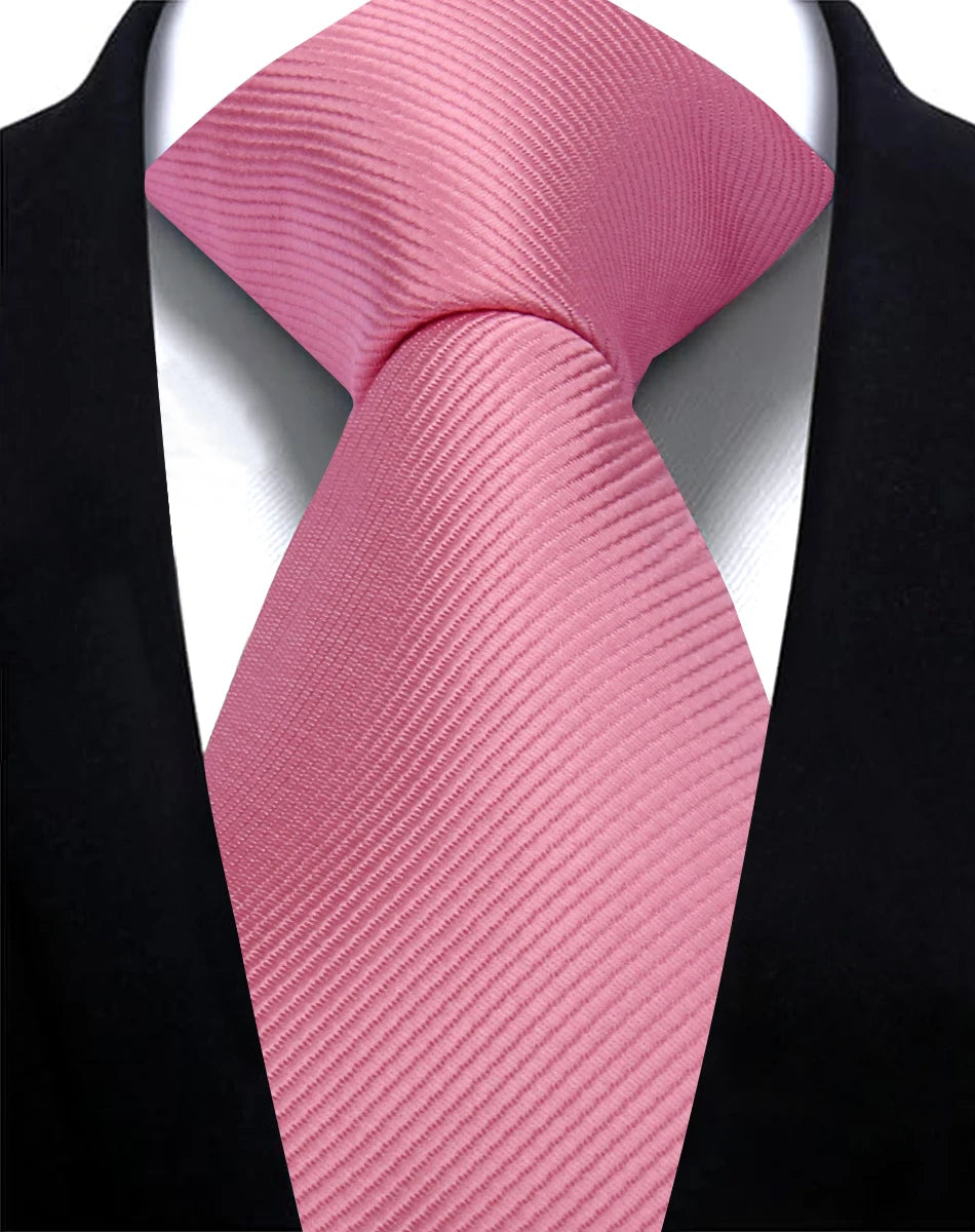 A pink silk necktie tied in a bow, displayed against a black suit jacket.