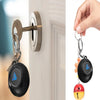 A black Magic 8 Ball keychain with a red top and yellow base hanging from a silver keyring.