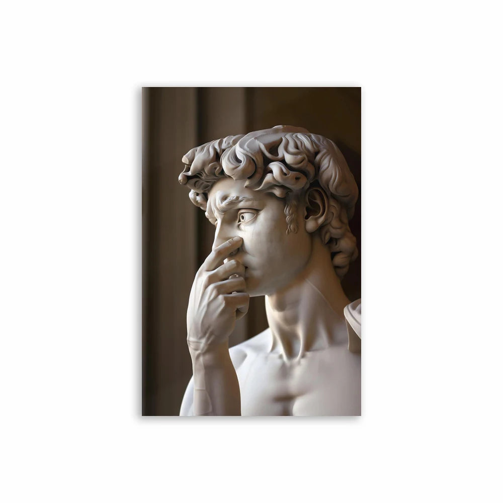 A marble sculpture of a face with curly hair looking to the side.