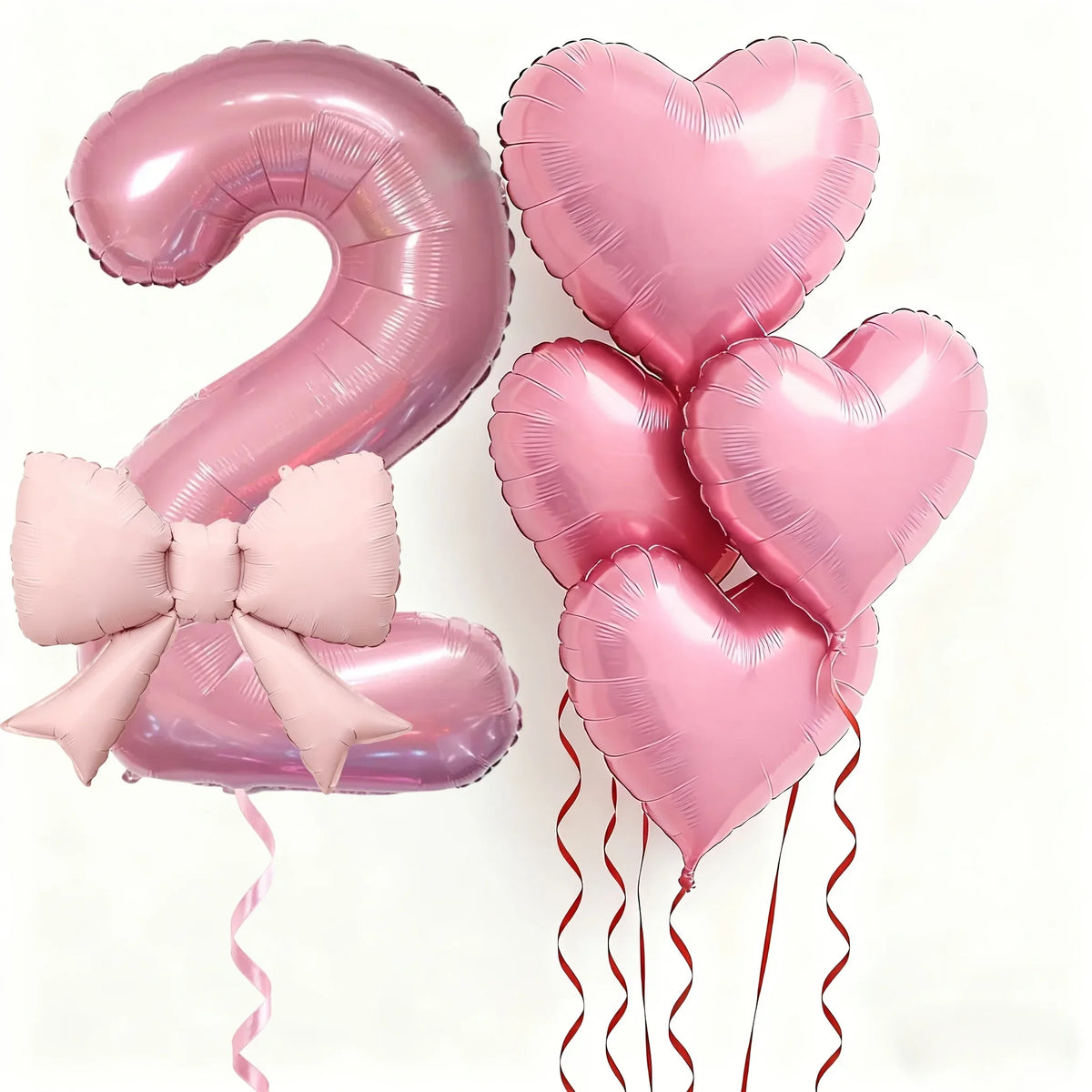 Pink foil balloons shaped like the number 2 and heart for party decoration