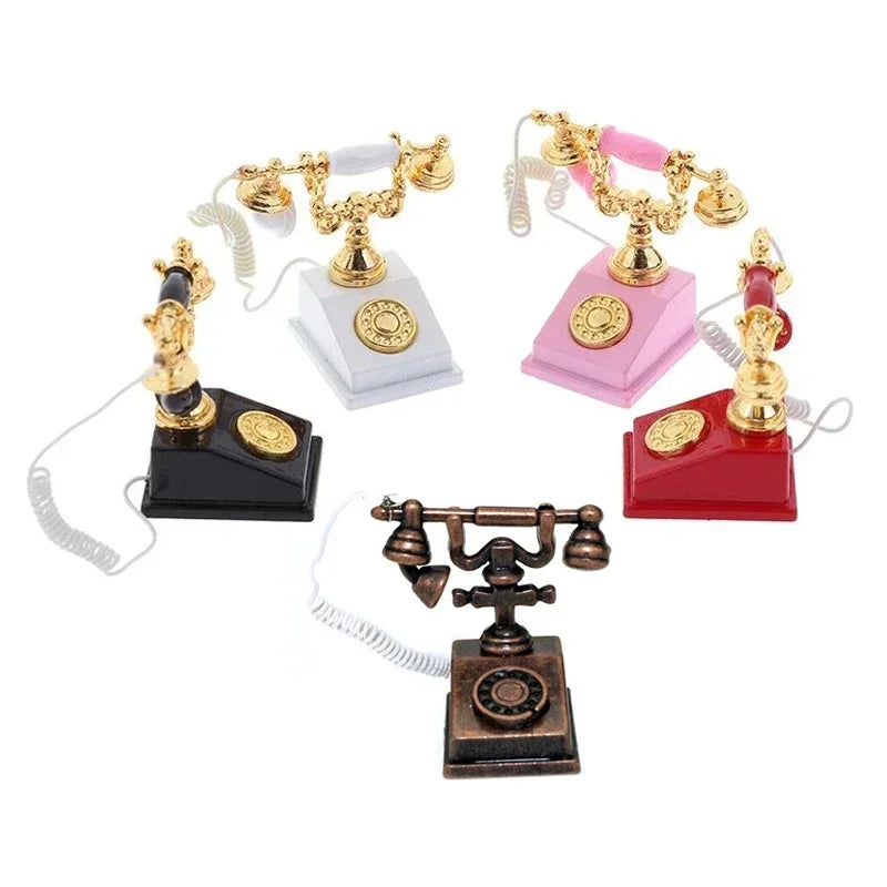 A collection of vintage rotary desk phone miniatures in gold and pink colors.
