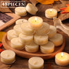 A collection of natural beeswax tealight candles in various sizes and shades arranged on a wooden board.