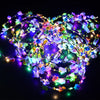 A glowing flower wreath headband with multiple colored LEDs illuminates a dark background.