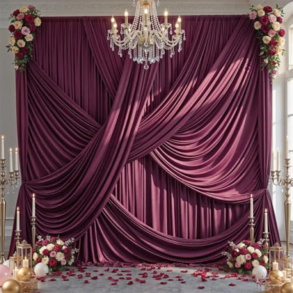 A luxurious deep purple satin backdrop curtain draped elegantly for parties and photography with floral accents.