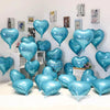 A collection of blue heart foil balloons displayed against a white wall.