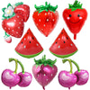 A collection of red and pink fruit-themed party balloons including strawberries, watermelon slices, and cherries.