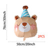 Two brown animal-themed foil balloons shaped like bears with striped conical tops