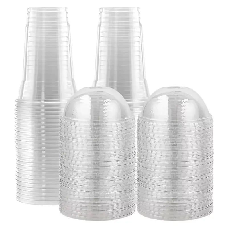 A stack of clear disposable plastic cups with lids for cold drinks.