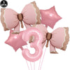 A set of five pink bow disposable party tableware items, including star-shaped and number three balloons.