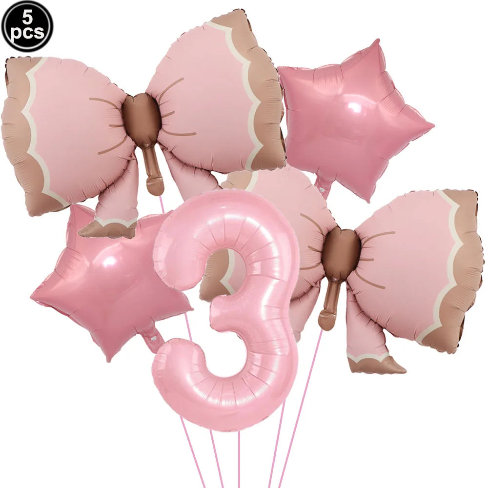 A set of five pink bow disposable party tableware items, including star-shaped and number three balloons.