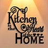Black silhouette wall art featuring the text Kitchen is the Heart of the Home in an elegant script font.