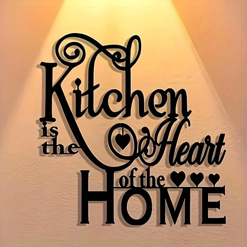 Black silhouette wall art featuring the text Kitchen is the Heart of the Home in an elegant script font.