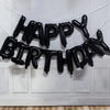 Black foil letter balloons spelling out Happy Birthday decoration set