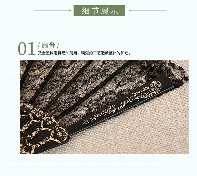 A close-up of a black vintage lace folding fan with intricate gold detailing, shown against a light background.