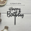 Elegant black acrylic birthday topper with a stick on a white wooden background