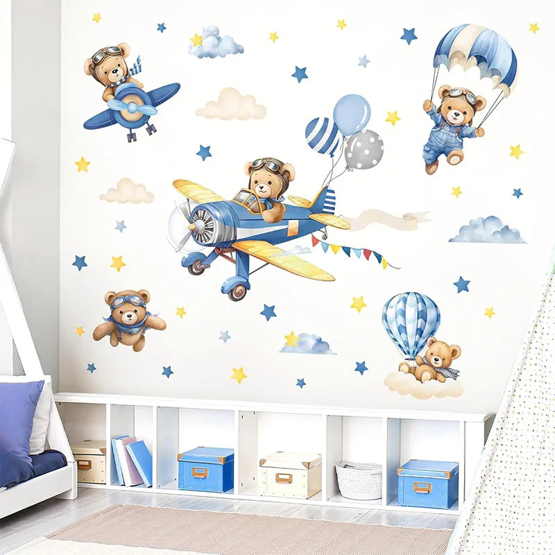 Wall stickers featuring teddy bear pilots and airplanes flying over clouds in a children's room setting
